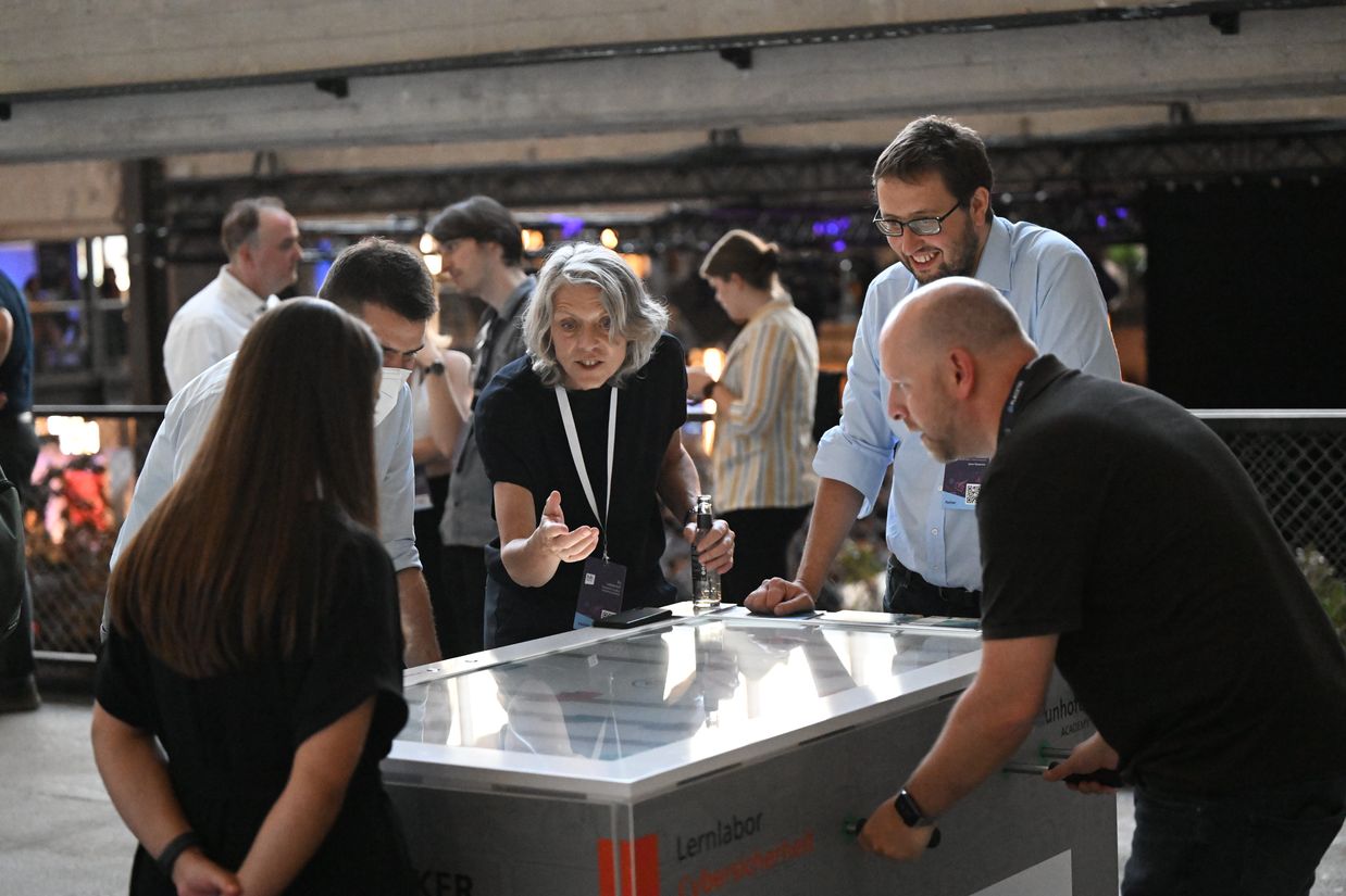 Cyber Foosball! Five people play "cyberkicker" on a virtual foosball table